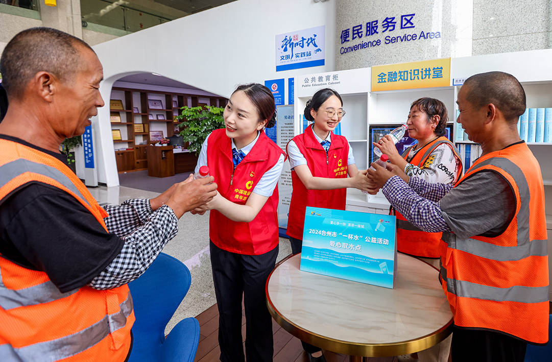 建行始终坚持人民至上和金融向善的价值追求，深入践行“三带一融合”公益理念，学习张富清先进事迹，培育和弘扬中国特色金融文化。图为2024年建行台州分行张富清金融服务队在劳动者港湾开展“一杯水”公益活动，为户外劳动者送上消暑饮品，传递建行浙江省分行“善建浙行”新金融公益品牌的温暖力量。.jpg